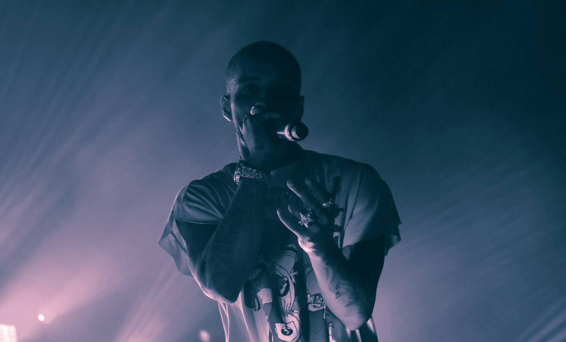 man in t-shirt holding microphone